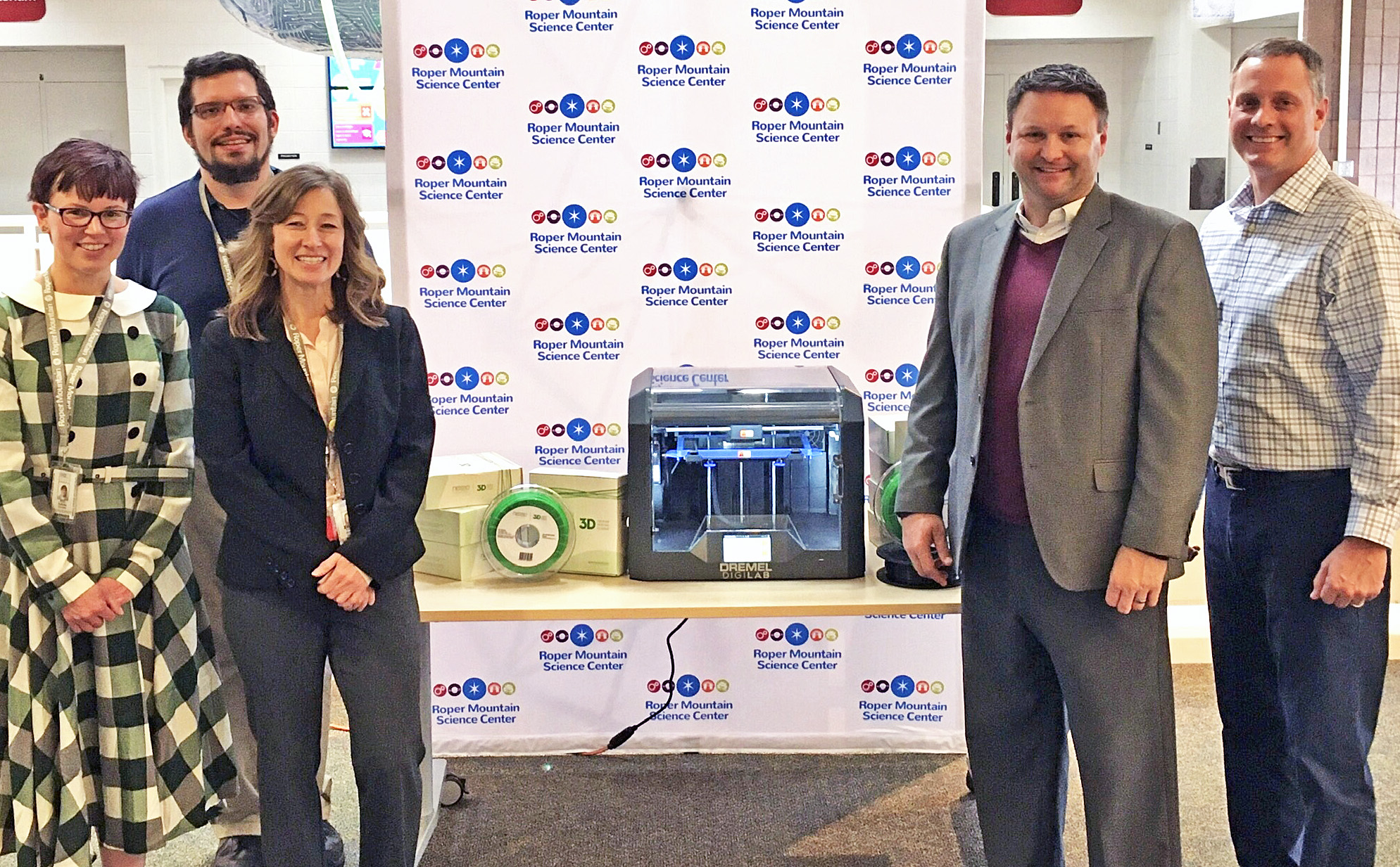 Erin Eudaly, STEM specialist, Joe Blizzard, STEM teacher, Valerie Mosher, STEM specialist, receive a 3D printer and supplies from Eric Roberts, Nexeo Plastics product line manager and David Burdock, Nexeo Plastics account manager.